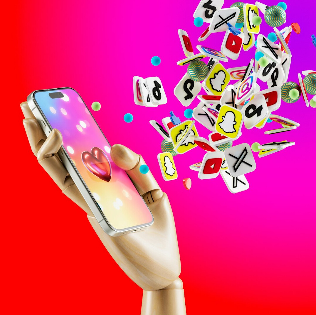 Hands holding a smartphone with colorful app icons