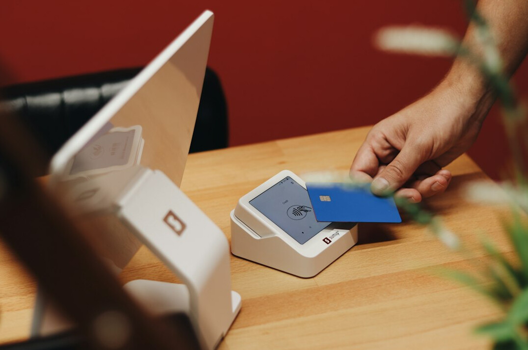 Desk with administrative papers, a laptop and a bank card